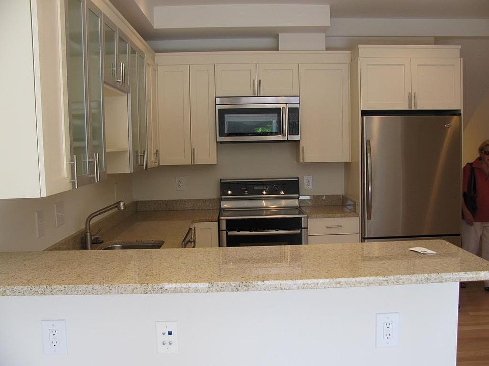 Kitchen (stairs down to main entrance bedrooms and full bath to right of fridge in this picture)
