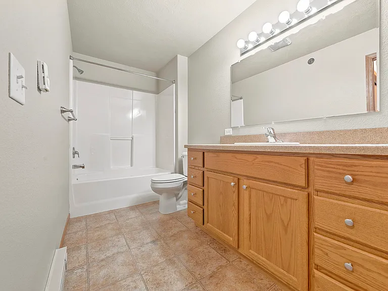 Step into your private retreat at Northdale Apartments, where modern amenities meet comfort. This inviting bathroom features stylish cabinetry and ample lighting, creating a serene atmosphere. Don't miss outschedule a visit today!