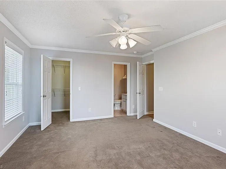 Master bedroom showing walk in closet and ensuite master bath