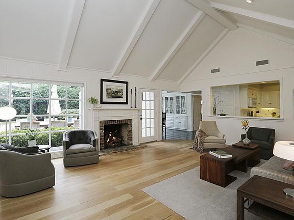 FAMILY ROOM (22'X16') Vaulted ceiling, wood floor, gas log fireplace and pass through to kitchen enhance the decor of the room.
