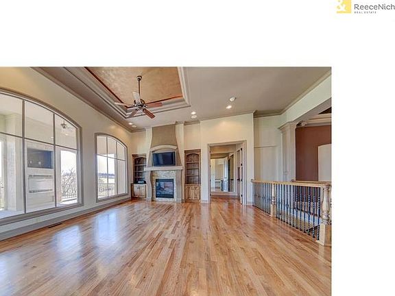 Hardwood floors in the great room. Note the beautiful ceiling treatment. The lanai has a gas fireplace and a place for a tv or a great niche to add lights and decorate.