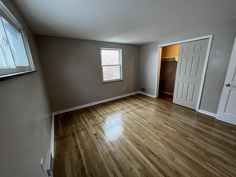 Back bedroom with polished hardwood floors