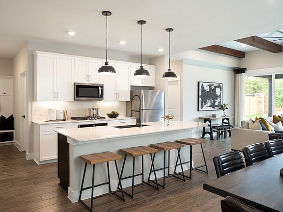 Open floorplan showcasing kitchen, spacious gathering room and dining areas