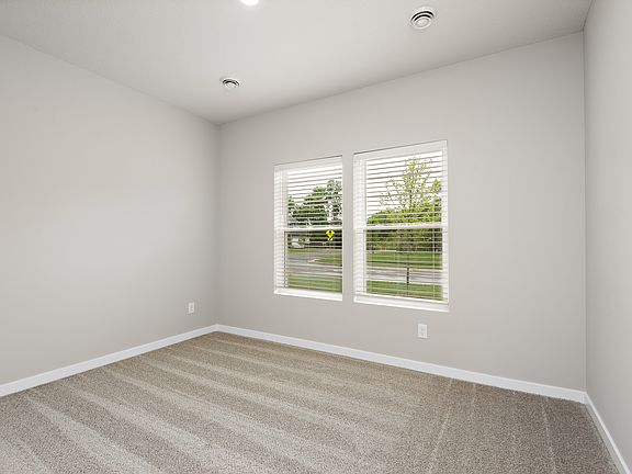 The master bedroom is spacious with a large window.