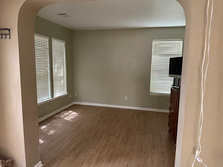 View from foyer into archway to front office. This space could be used for so many things - maybe an extended mud room as it's next to the foyer. It was used by the owner as a music room for many years.