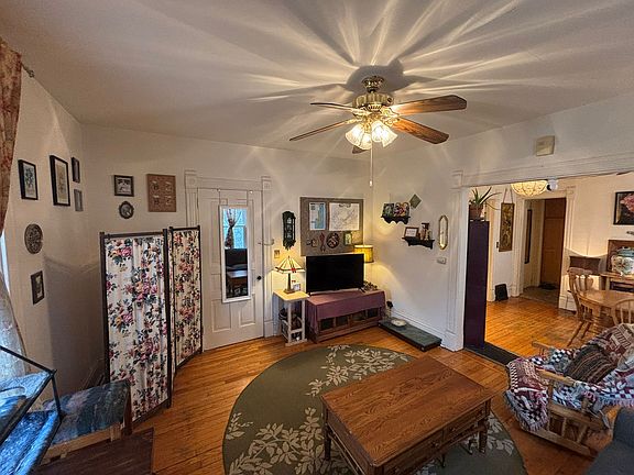 Living room showing front hallway door (with mirror).