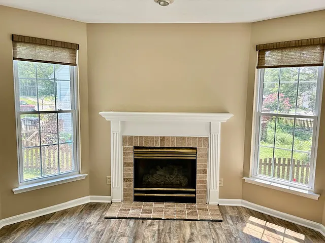 Accent light above natural gas fireplace and privacy blinds.