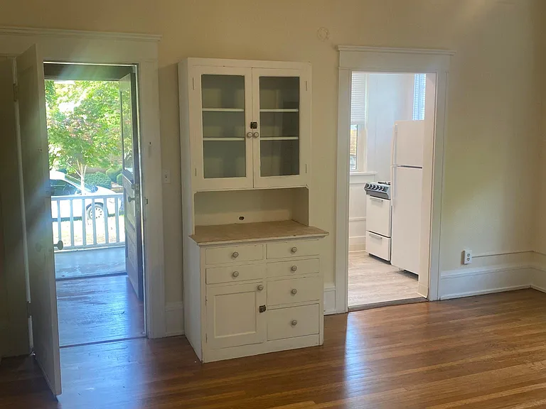 Looking out towards entrance in front room with built in hutch