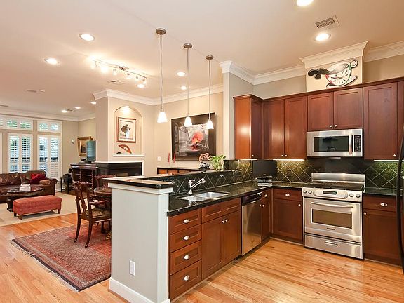 FIRST FLOOR-kitchen features Upgraded Stainless refrigerator, Kitchen-aid professional gas range and High CFM Microwave and vent. Breakfast bar with pendant lighting