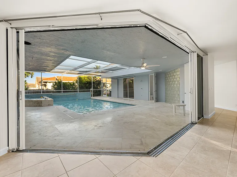 Rare courtyard design with direct pool access and views from throughout the home.