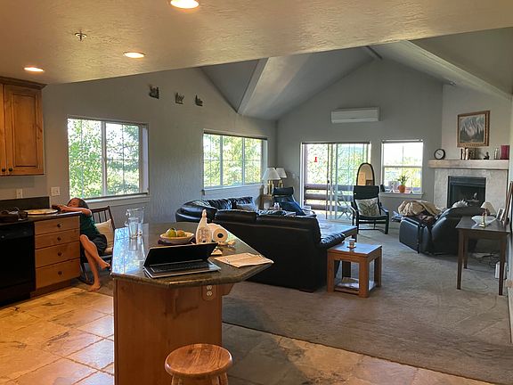kitchen/living area looking East into trees, mountains and lake.
