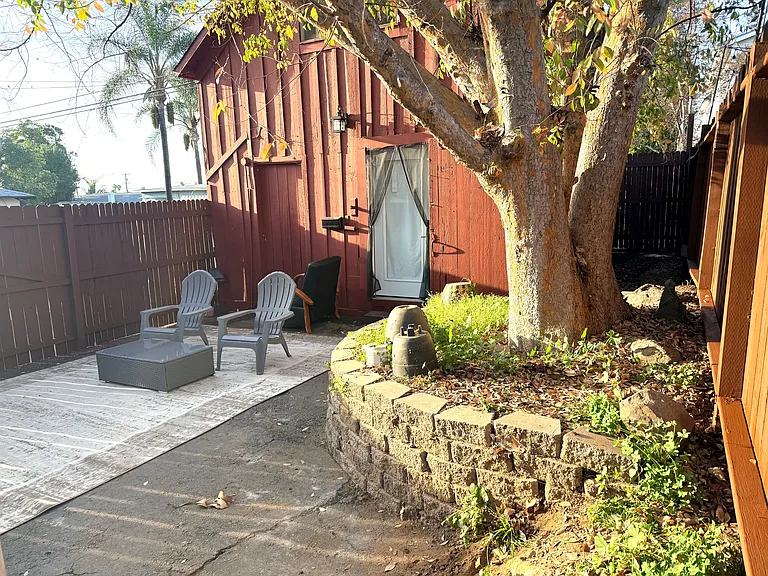 Massive tree makes lots of shade for the outdoor area (firepit not shown in photo)