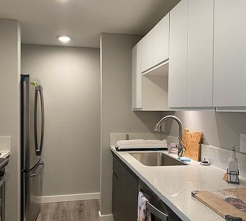 Kitchen features beautiful LVT flooring, granite counters and all new stainless appliances