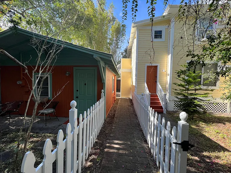 Rear door and side yard for this apartment is on the right.