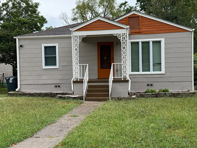 House exterior repainted in 2024. Features Picture window within living room. Two flower beds in front. Also has front porch light along with security camera
