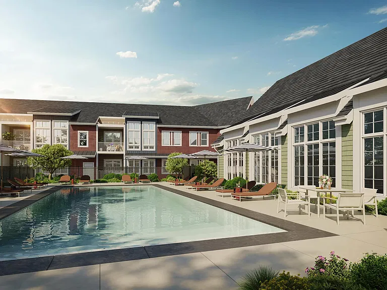 Outdoor pool and sun deck framed by tailored landscaping and comfortable seating, offering a refined setting to recharge or connect outdoors.