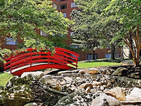 A fire-engine red footbridge behind the property's hot whirlpool bath.