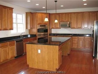 Kit. #2 elegant pendant lighting and all stainless steel appliances.