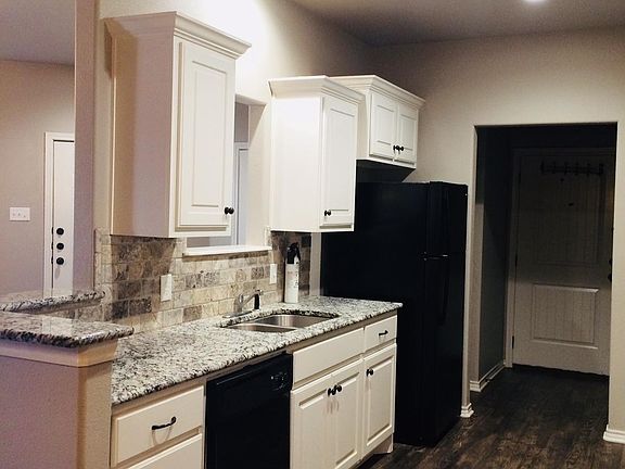 Open kitchen with beautiful white and gray granite. Raised,