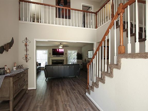 Gorgeous front foyer highlighting a soaring two story ceiling, beautiful light fixtures, vinyl plank floors, and a wonderful open living concept!