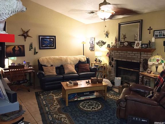 Living Room w/Fireplace. Large tile flooring throughout.