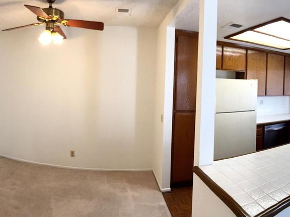 Dining area with ceiling fan and kitchen