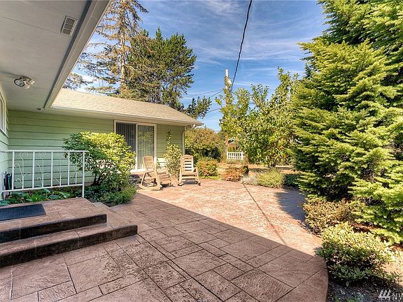 A welcoming front courtyard with decorative stamped concrete.
