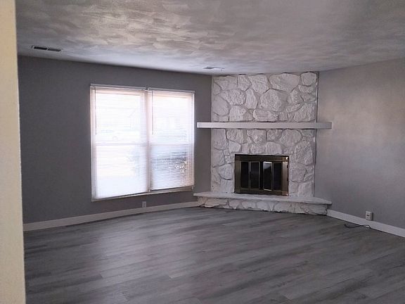 NEW FLOORING & NEWLY PAINTED. NON- WORKING FIREPLACE