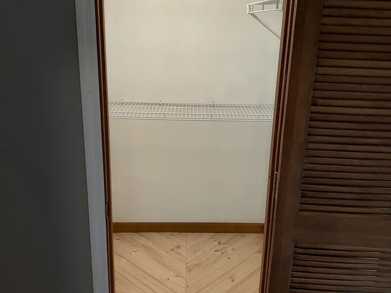 1 of 2 walk in closets for master bedroom.
