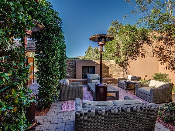 Spacious courtyard with comfortable furnishings, a gas fireplace and heater