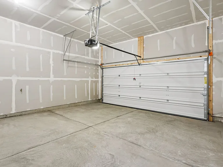Covered two car garage with access to the First floor