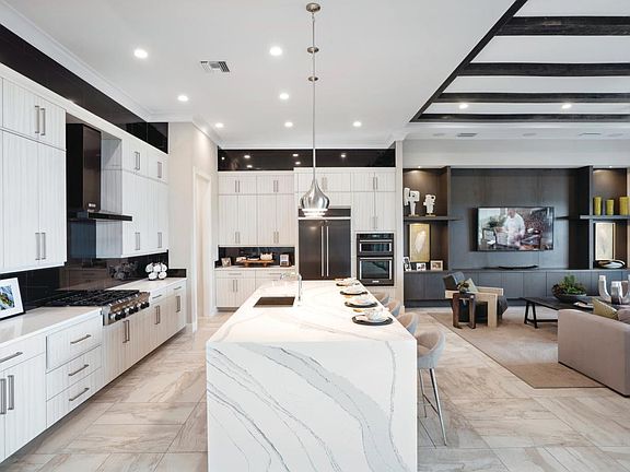 Gourmet kitchen with large center island connects to the open-concept great room