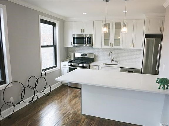 New eat-in kitchen with sleek quartz counters, ss appliances and tons of cabinets