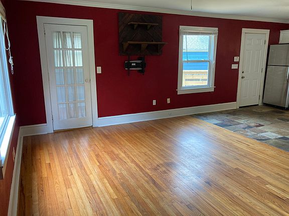 Living room and kitchen from front door, custom tv mount and shelves.