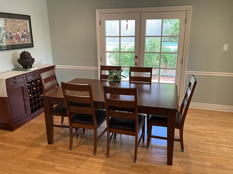Dining area adjacent to French doors and patio