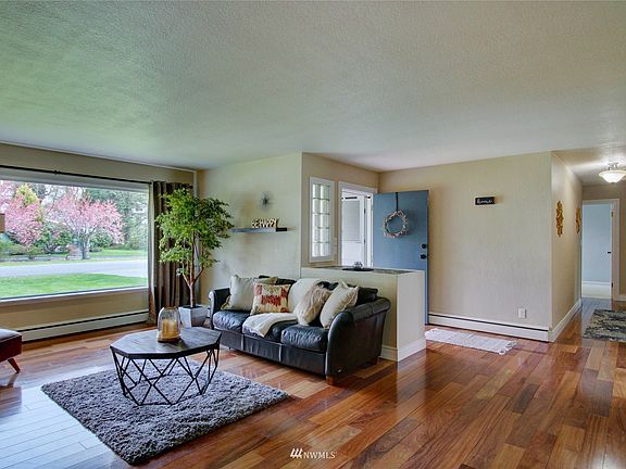 Entry into stylish living room with Brazilian teak hardwood floors. 