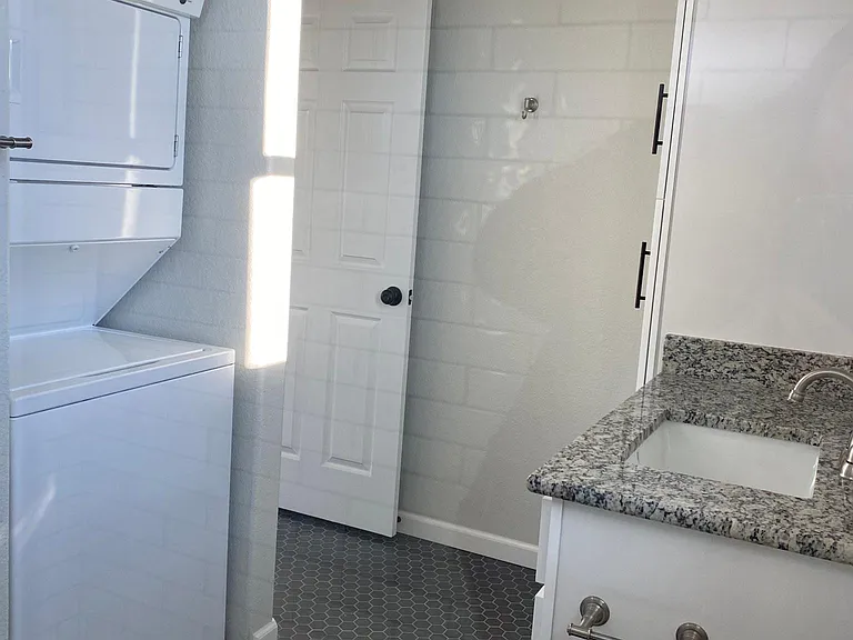 The laundry unit is tucked away in the bathroom with space above for even more storage like detergents and paper products.