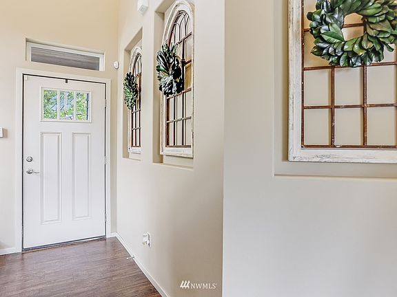 Entryway with vaulted ceilings and picture frame out coves, greet you as you open the front door.