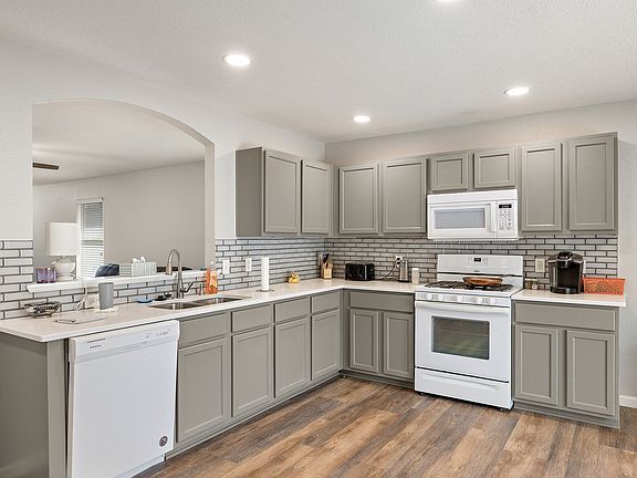 Remodeled modern large kitchen with quartz countertops, new backsplash