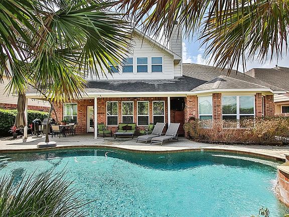 A backyard oasis that serves as the perfect space for entertaining or quiet relaxation! Beautiful saltwater pool and spa features Pebble Tec finish, known for it's durability. A gas firepit is in place for those cooler evenings