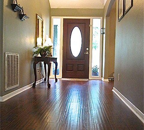 Enter to gleaming wood (laminate) floors that are a decorative hand scraped plank giving this entry lots of character and an inviting atmosphere.