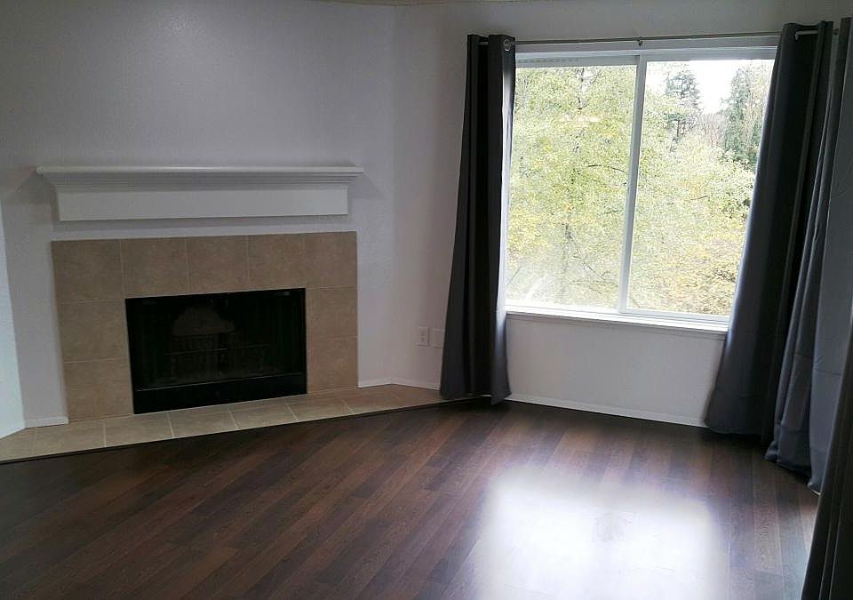 Large living room with over sized windows that let in tons o