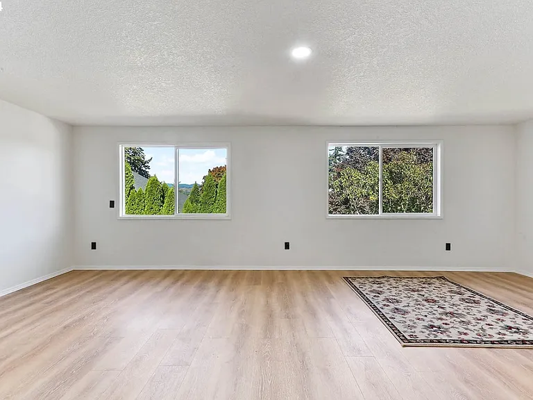 Extra-large primary bedroom with walk-in closet (unfurnished photo)