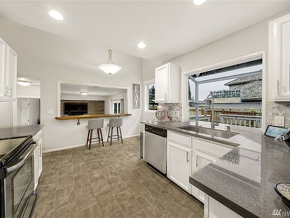 Updated kitchen with sharp quartz countertops and garden window. 