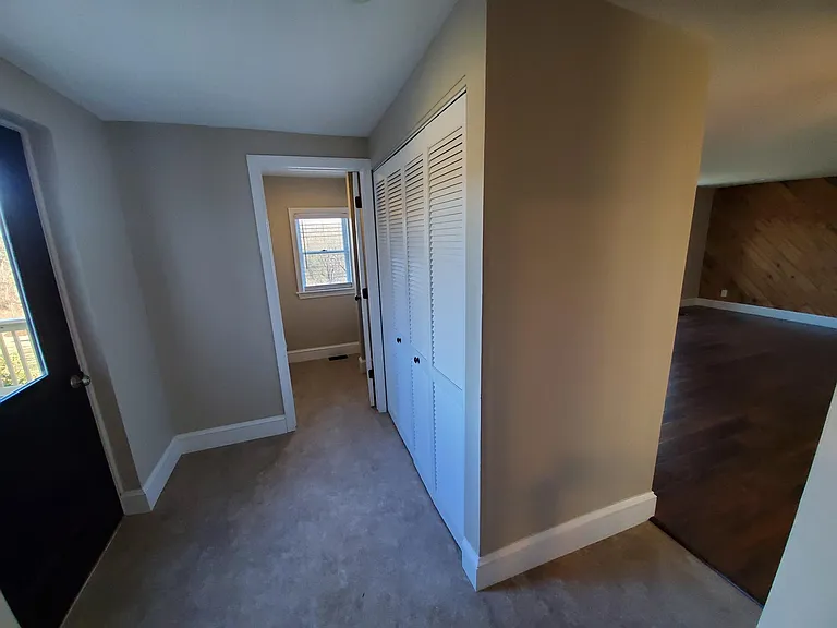 Laundry area, washer/elec dryer hookup behind louver doors, door to back deck and 1st floor bathroom, family rm off to right