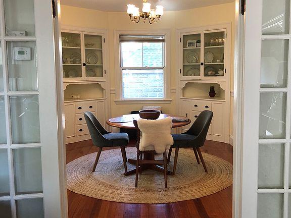 view of DR from back parlor through French doors; built in China cabinets with ample storage at back of DR