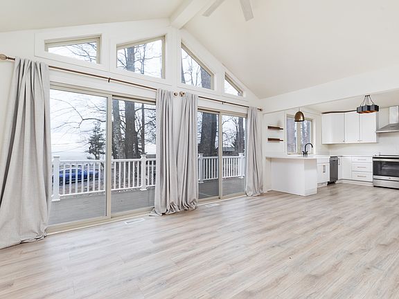 Open floor plan living room and kitchen with sliding doors to the deck.
