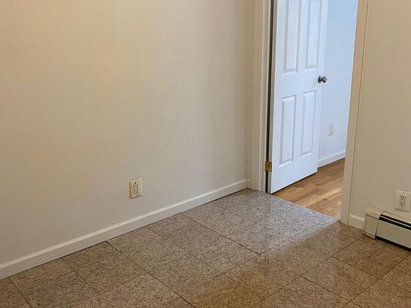 Kitchen area for table. Door to back bedroom.