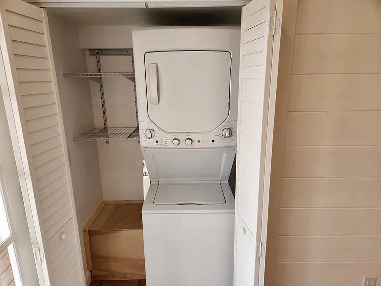 New efficient stackable gas washer and dryer with laundry storage.