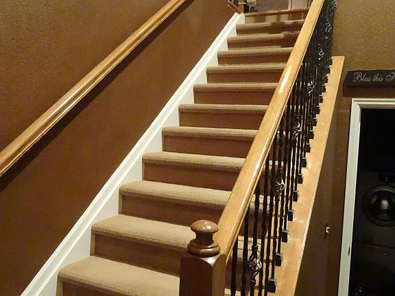 Front entry with stairs to living space and laundry room/garage entrance to the right